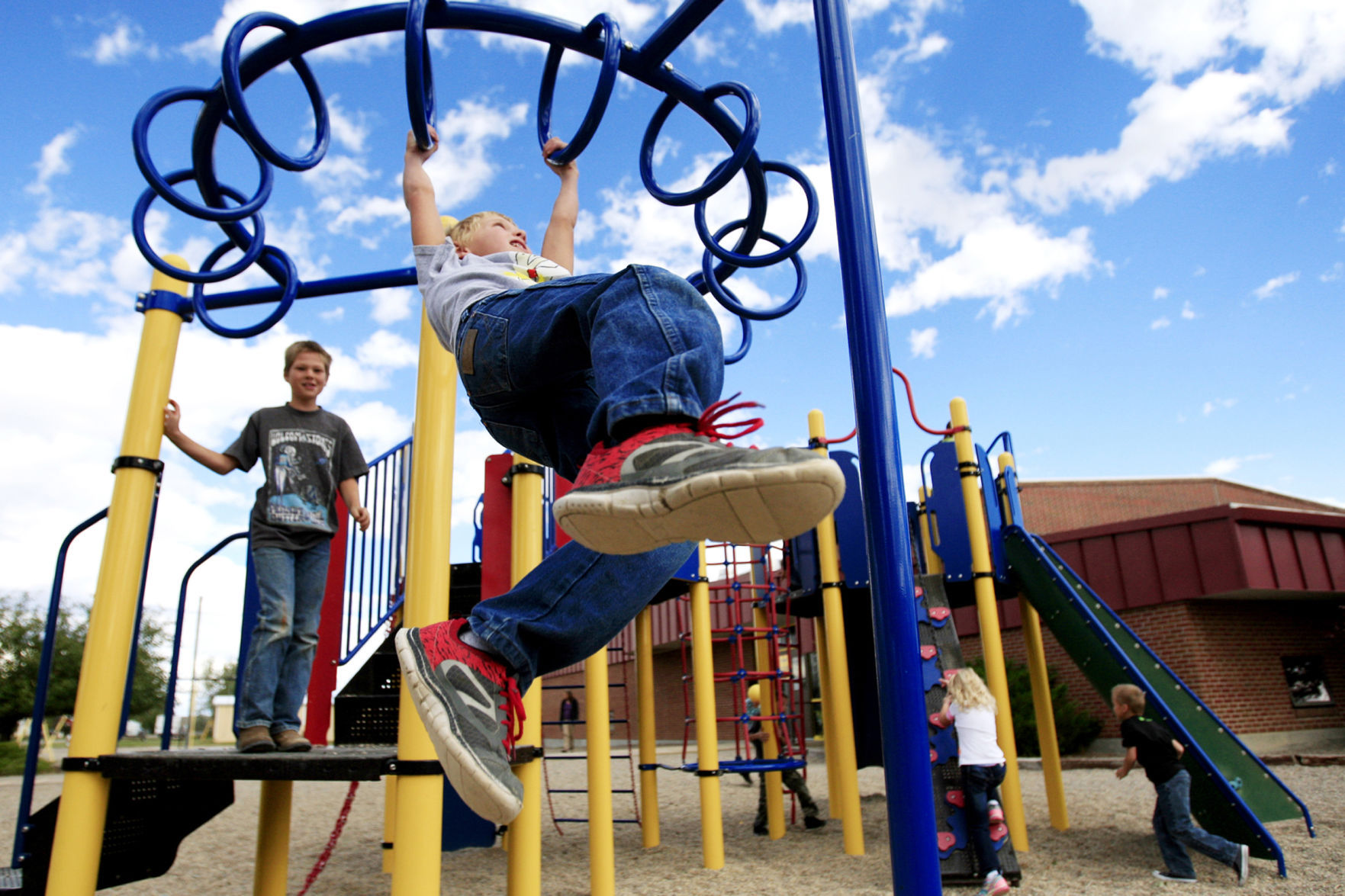 Trey Jassak hangs from monkey bars